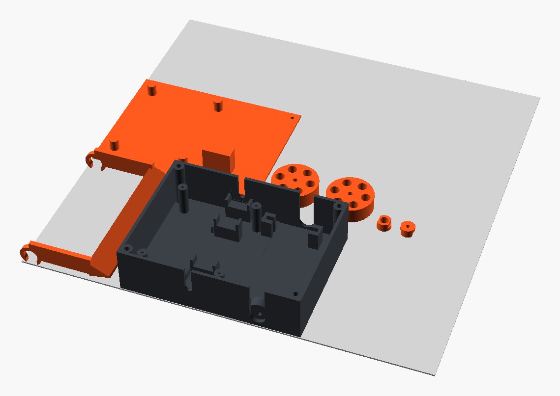 The PETG print plate: the dark chassis tub with its rim-open slots, the orange lid printed upside down with its clamp bosses up, the lifter fork lying flat, two wheel hubs and two small keyed pivot hubs, all on a 256 mm bed